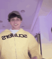 a blurry picture of a person wearing a yellow jacket that says t-max on it