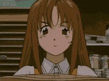 a girl is holding a stack of papers in front of her face