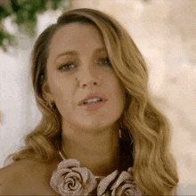 a woman wearing a necklace with flowers on it
