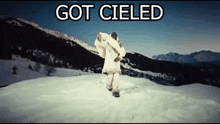 a man in a white coat is standing in the snow with the words got cieled above him