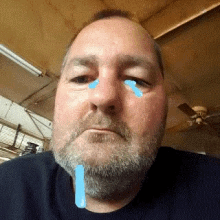 a man with a beard and tears on his face