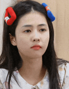 a close up of a woman 's face with sesame street hair clips in her hair