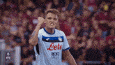 a soccer player wears a white jersey with the word lete on it