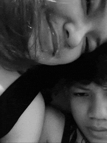 a black and white photo of a woman and a boy