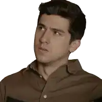 a man in a brown shirt looks to his left