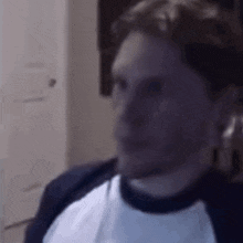 a close up of a man 's face in a room .