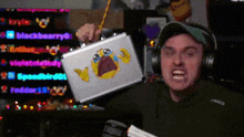 a man wearing headphones is holding a briefcase with a crying face sticker on it