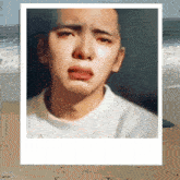 a painting of a man 's face with a beach in the background