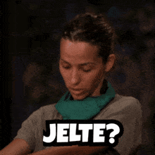 a woman with a green scarf around her neck has the word jelte on her shirt