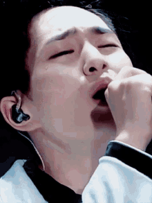 a man is crying while singing into a microphone