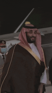 a man with a beard wearing a traditional arabian costume