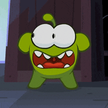 a green cartoon character with a red mouth and teeth