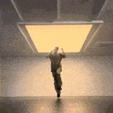 a man is jumping in the air under a large yellow light