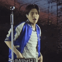 a man wearing a blue jacket and a striped shirt
