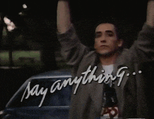 a man with his arms in the air and the words say anything