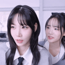 two girls are standing next to each other and one has a headband on
