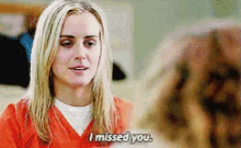 a woman in an orange shirt says i missed you .