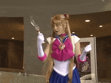 a woman dressed as sailor moon is holding a knife
