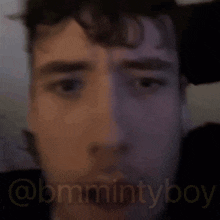 a close up of a man 's face with the words " @bmmintyboy " in the corner