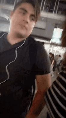 a man wearing headphones is talking to a woman in a striped shirt