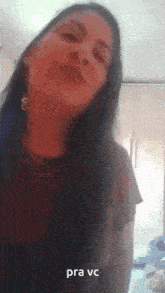 a woman with long hair and earrings says pra vc on the bottom of her face