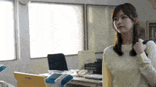 a woman stands in front of a panasonic laptop