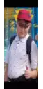 a boy wearing a red hat and sunglasses is giving a thumbs up sign .