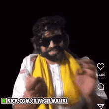 a man wearing sunglasses and a yellow scarf with the words kick.com/ilyaselmaliki on the bottom