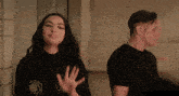 a man and woman are standing next to each other