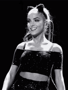 a black and white photo of a woman wearing a cat ear headband