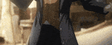 a man in a suit and tie is standing in a room with his arms outstretched .