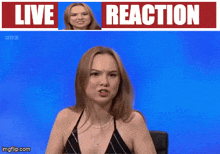 a woman in a bikini is sitting in front of a live reaction banner
