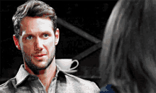 a man with a beard is looking at a woman