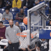 a basketball player with the number 12 on his jersey is playing basketball
