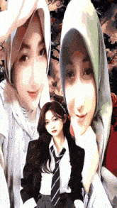 a woman in a hijab and a woman in a suit are posing for a picture together