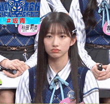 a girl in a plaid vest has a name tag that says dec on it