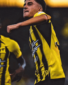 a soccer player wearing a yellow jersey with the number 21 on it