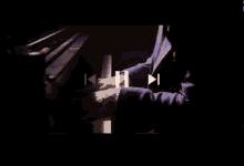 a man is playing a piano in a dark room in a dark room .