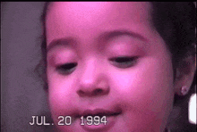 a close up of a child 's face with the date july 20 1994 on the bottom