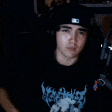 a man wearing headphones and a hat that says ' mlb ' on it