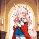 a girl with a fox 's head is holding a mushroom in her hands