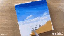 a painting of a beach with the word sea painted on it