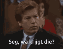 a man in a suit and tie with the words seg wa krijgt die below him