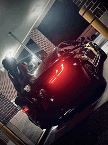 a black car is parked in a parking lot with a red light on the back