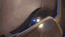 a close up of a person wearing sunglasses with a blue light coming out of it