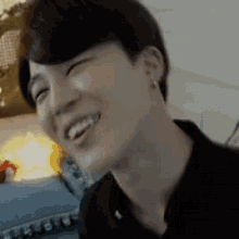 a close up of a person 's face with their eyes closed and a smile on their face .