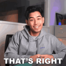 a man wearing a grey hoodie with the words that 's right on the bottom