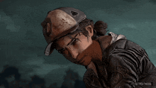 a person wearing a baseball cap with the letter d on it looks down