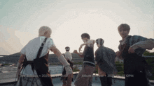 a group of young men are dancing on a rooftop with the words mv release 2025 written on the bottom