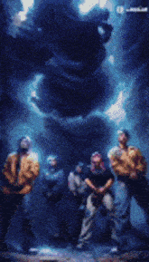 a group of people are standing in front of a giant statue